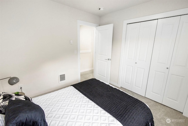 carpeted bedroom with a closet