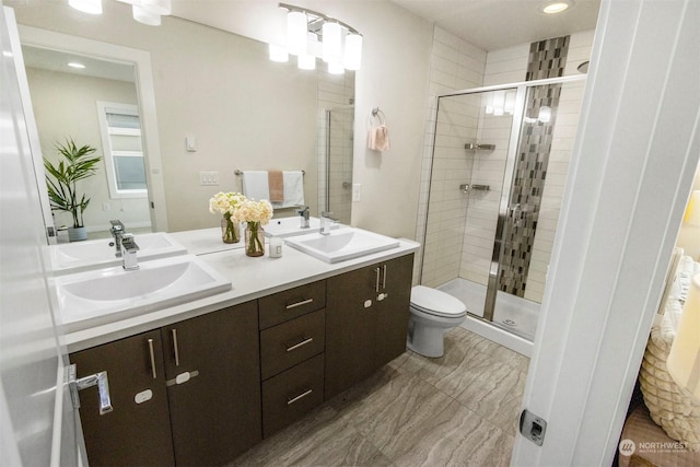 bathroom featuring vanity, toilet, and an enclosed shower