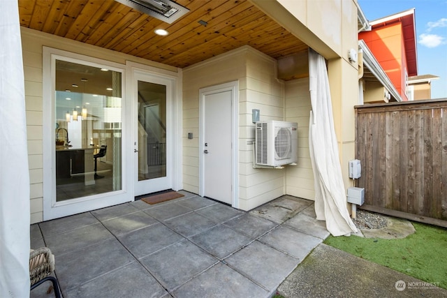 entrance to property featuring ac unit and a patio area