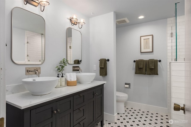 bathroom with vanity, toilet, and tile patterned flooring