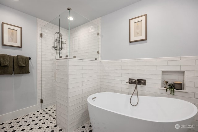 bathroom with independent shower and bath and tile patterned floors