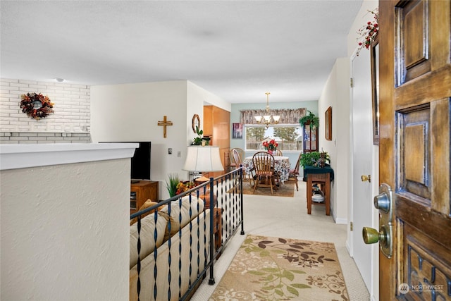 carpeted foyer featuring a chandelier