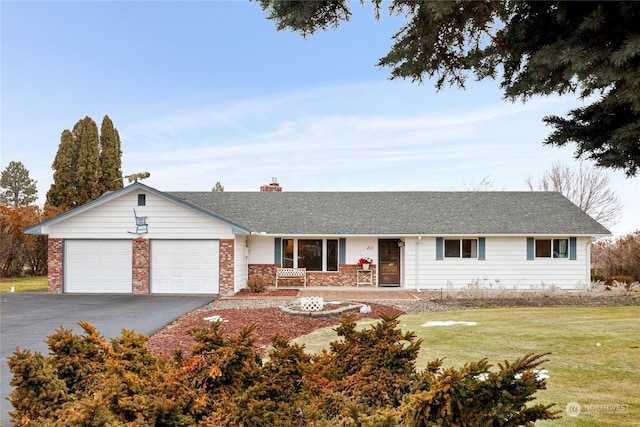 ranch-style home featuring a garage and a front lawn