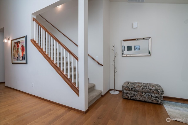 stairway with hardwood / wood-style flooring