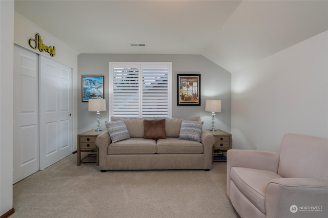 carpeted living room featuring lofted ceiling