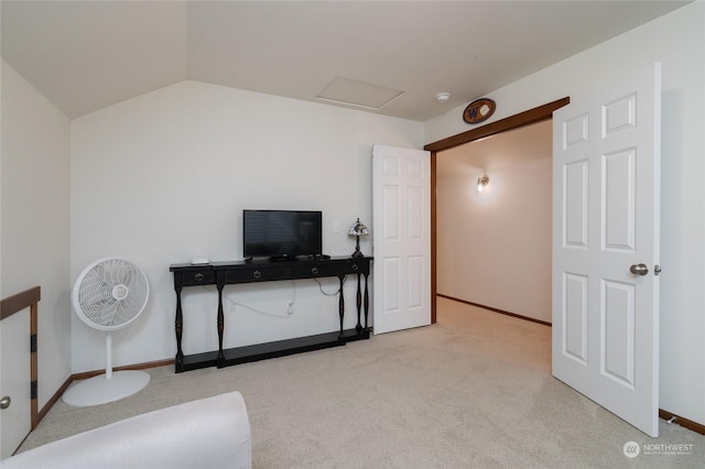 interior space with lofted ceiling and light carpet