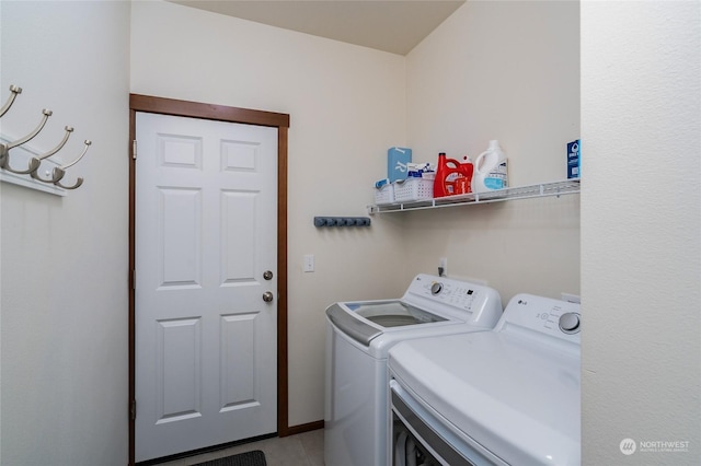 clothes washing area with washing machine and clothes dryer