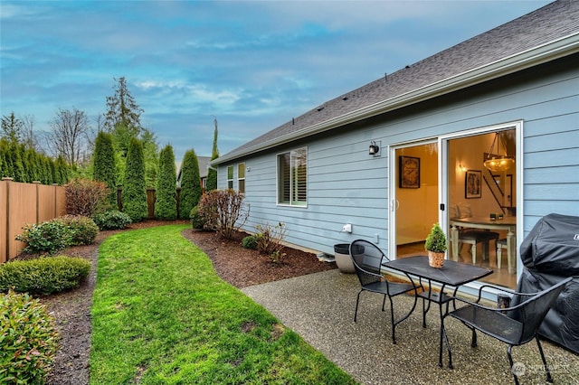 rear view of house with a yard and a patio