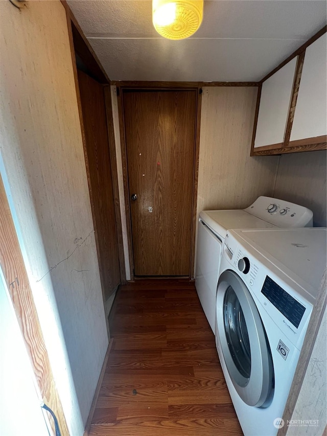 laundry area with cabinets, dark hardwood / wood-style flooring, and independent washer and dryer