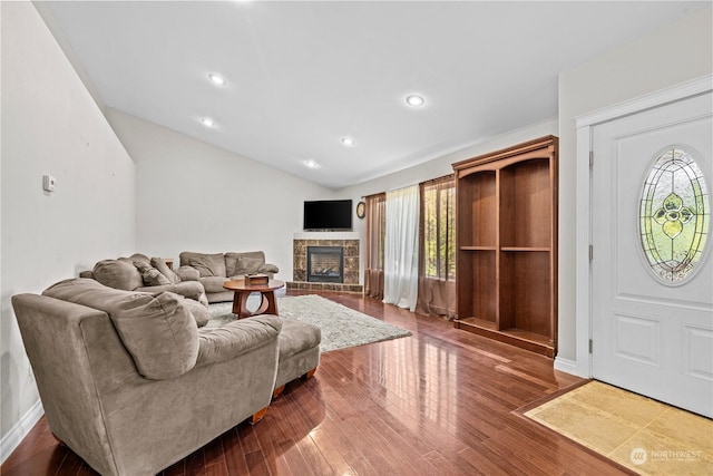 living room featuring plenty of natural light, dark hardwood / wood-style floors, and a fireplace