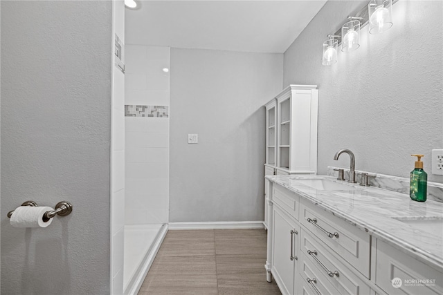 bathroom featuring vanity and a shower