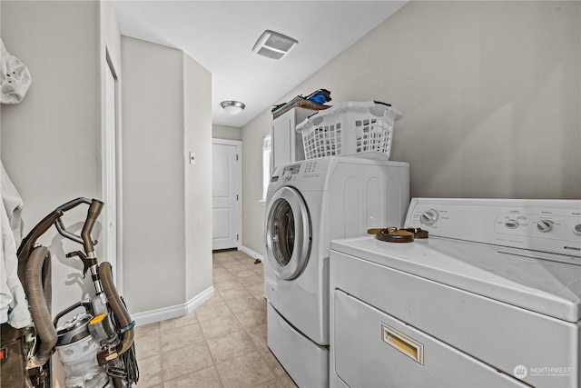 clothes washing area featuring cabinets and washer and dryer