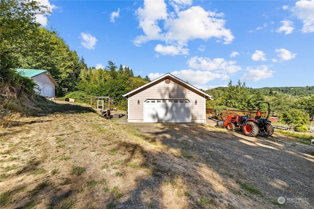 exterior space featuring an outbuilding and a garage