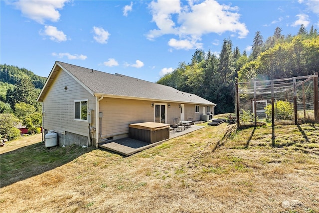 rear view of house with a patio area and a lawn