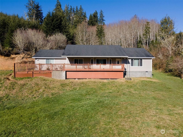 rear view of property featuring a wooden deck and a yard