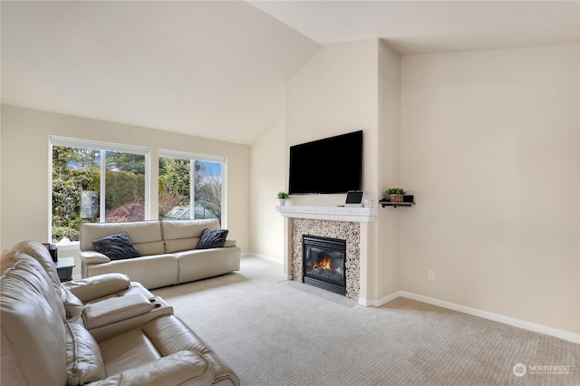 carpeted living room with a fireplace and vaulted ceiling