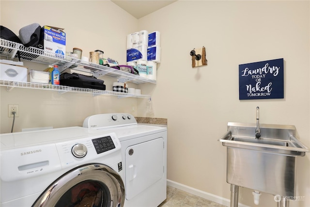 clothes washing area featuring washer and clothes dryer and sink