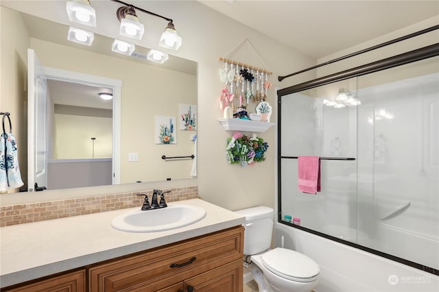 full bathroom with vanity, decorative backsplash, enclosed tub / shower combo, and toilet