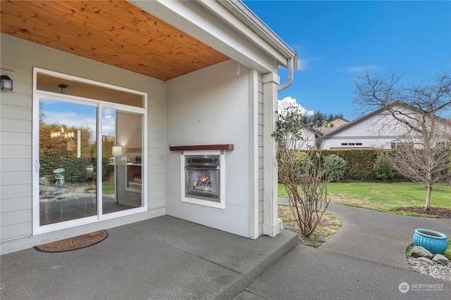 view of patio featuring exterior fireplace