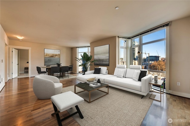 living room with expansive windows and dark hardwood / wood-style flooring