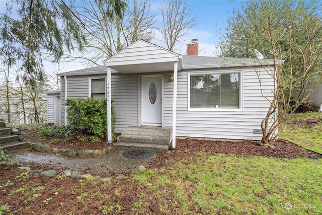 bungalow-style house with a front yard