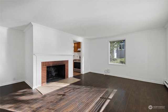 unfurnished living room with crown molding, a brick fireplace, and hardwood / wood-style flooring