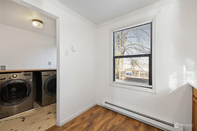 laundry area with a baseboard heating unit, crown molding, wood-type flooring, and independent washer and dryer