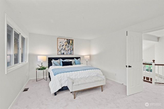 bedroom featuring light colored carpet