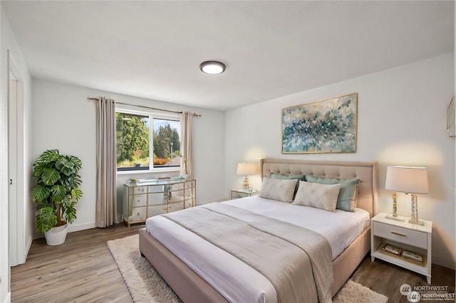 bedroom with hardwood / wood-style floors