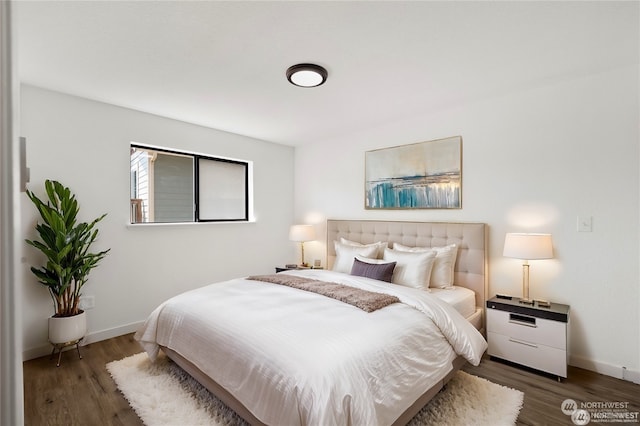 bedroom with dark hardwood / wood-style flooring