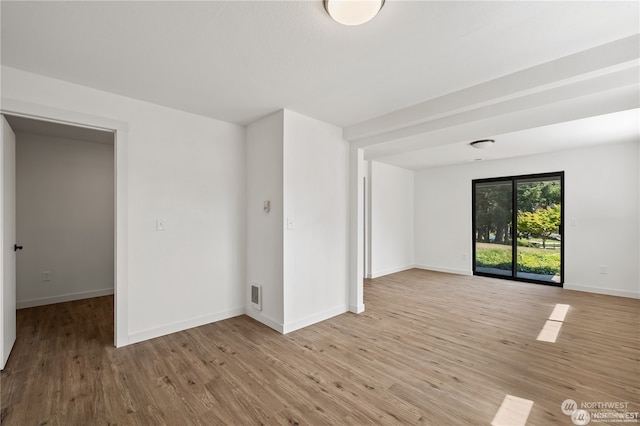 spare room featuring light hardwood / wood-style floors