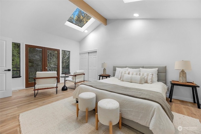 6111 145th St SW, Edmonds, WA 98026 - bedroom featuring a skylight, light hardwood / wood-style floors, french doors, and beamed ceiling