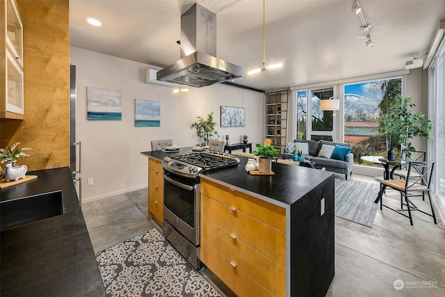 kitchen with a kitchen island, island range hood, concrete floors, gas stove, and track lighting