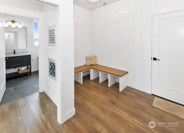 mudroom with sink and hardwood / wood-style flooring