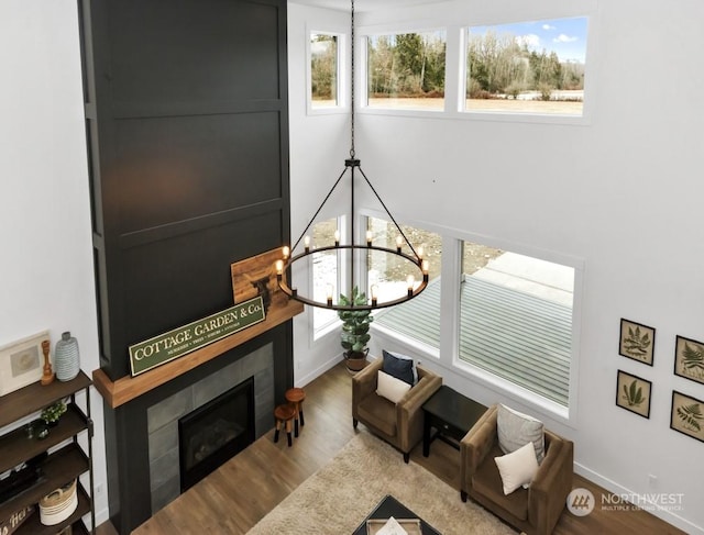 living room featuring plenty of natural light, a chandelier, and hardwood / wood-style floors