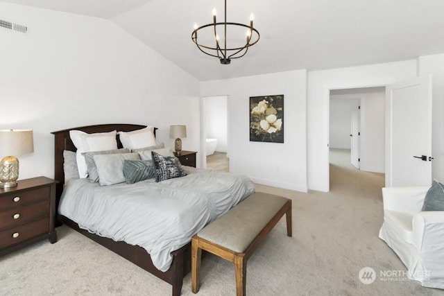 carpeted bedroom with connected bathroom, vaulted ceiling, and a notable chandelier