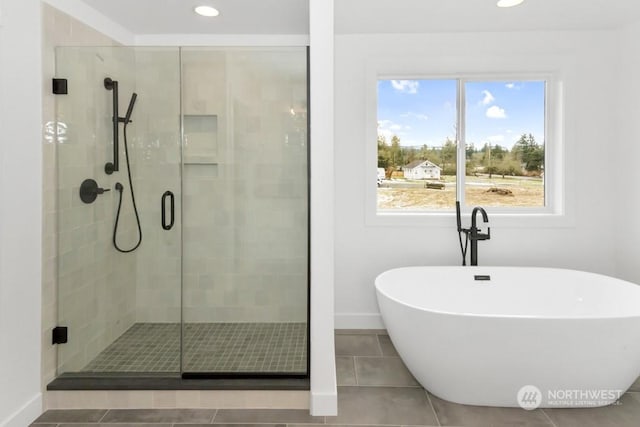 bathroom featuring tile patterned floors, a healthy amount of sunlight, and shower with separate bathtub