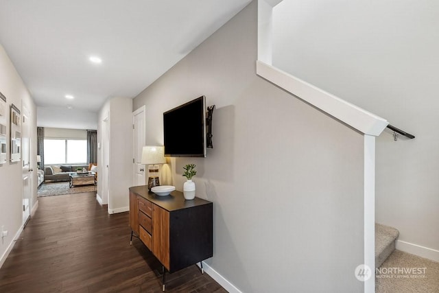 corridor with dark hardwood / wood-style flooring