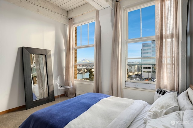 bedroom with a water view and carpet flooring