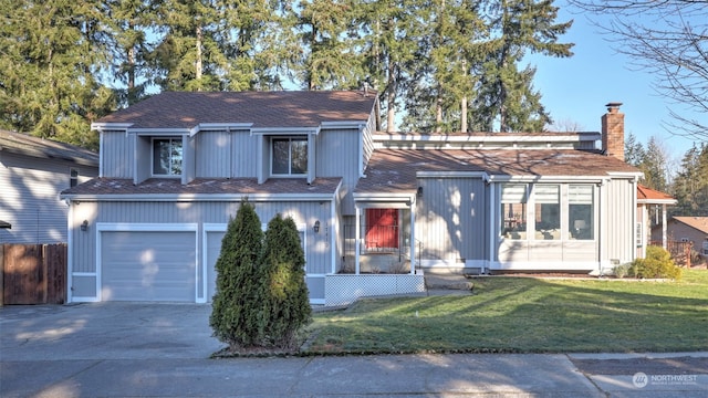 view of front of house featuring a garage and a front lawn