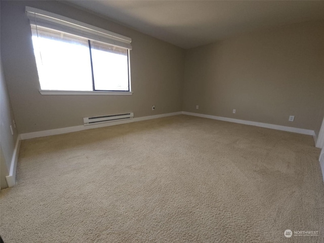 carpeted spare room with baseboard heating