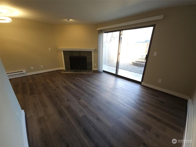 unfurnished living room featuring dark hardwood / wood-style floors, a baseboard radiator, and a fireplace