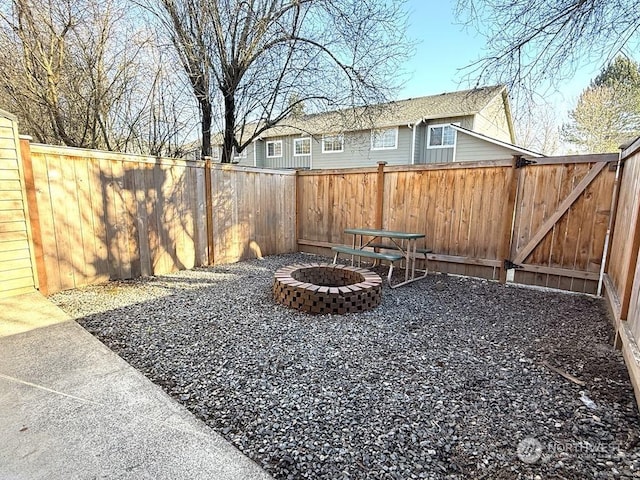 view of yard with a patio and an outdoor fire pit