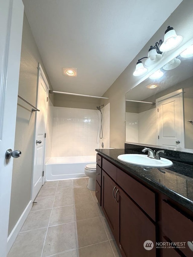 full bathroom featuring tiled shower / bath, vanity, toilet, and tile patterned flooring