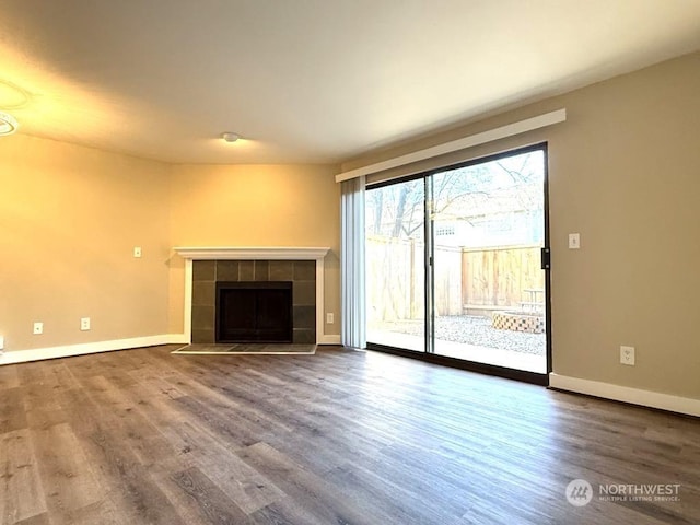 unfurnished living room with hardwood / wood-style flooring and a fireplace