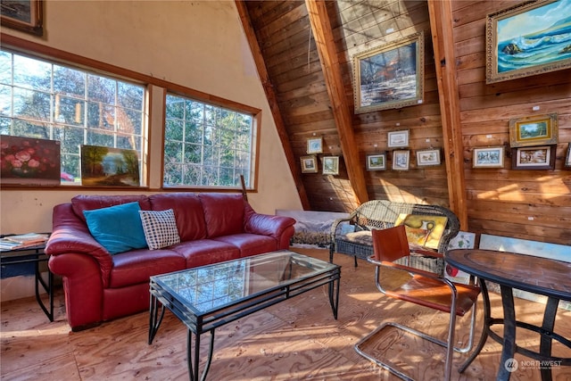 living room featuring vaulted ceiling and wood walls