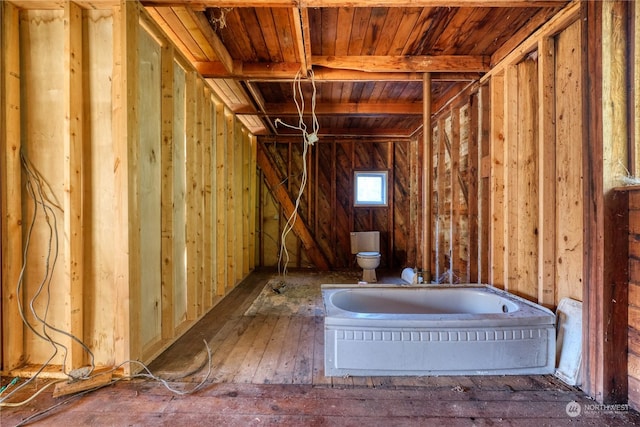 bathroom with wooden ceiling, beam ceiling, and toilet