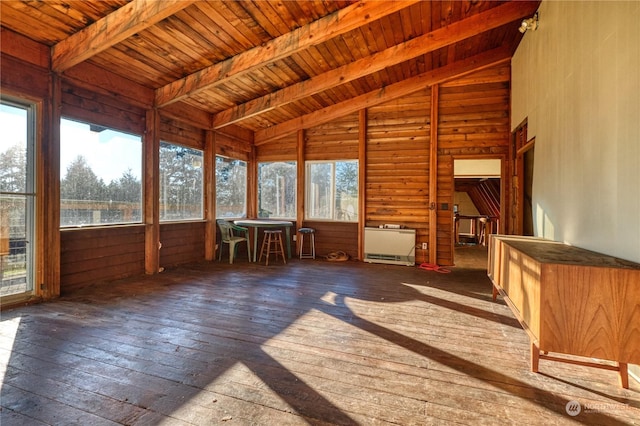 unfurnished sunroom with lofted ceiling with beams, plenty of natural light, and wood ceiling