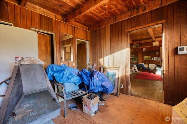 misc room with wooden walls and beam ceiling