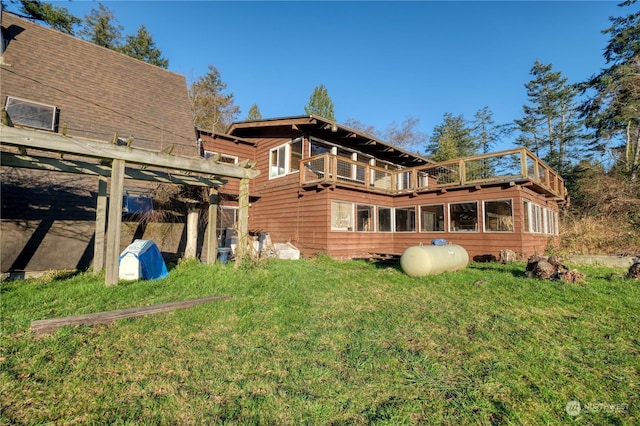 rear view of house featuring a yard